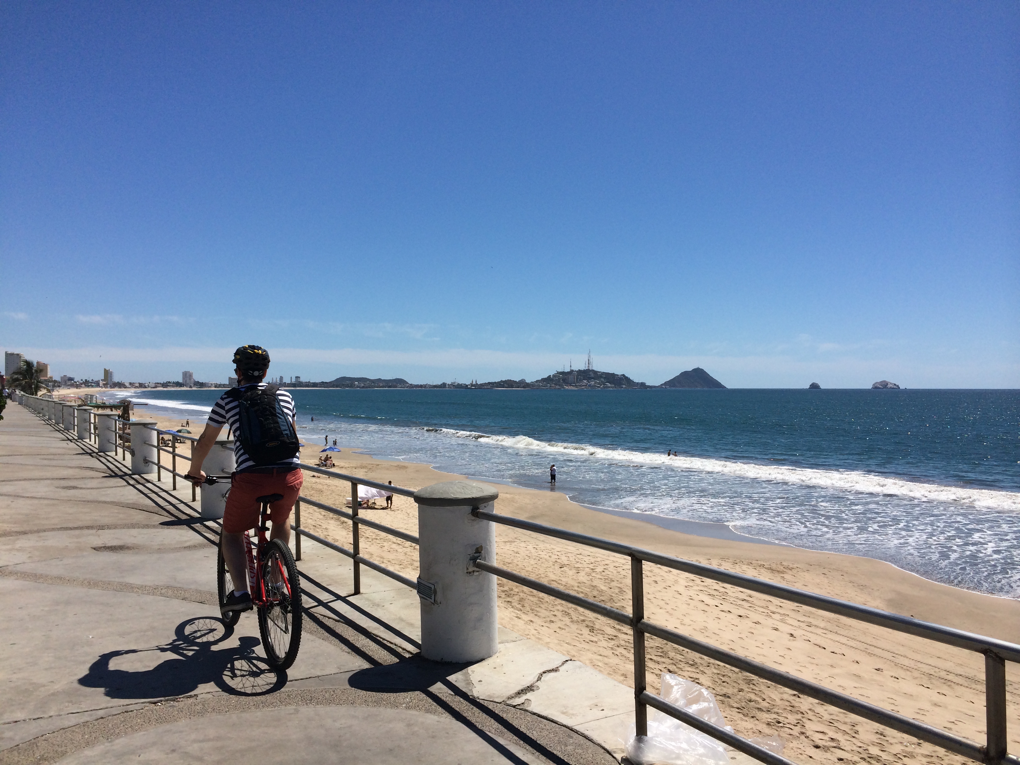 A visitor bicycles along the Malecon.