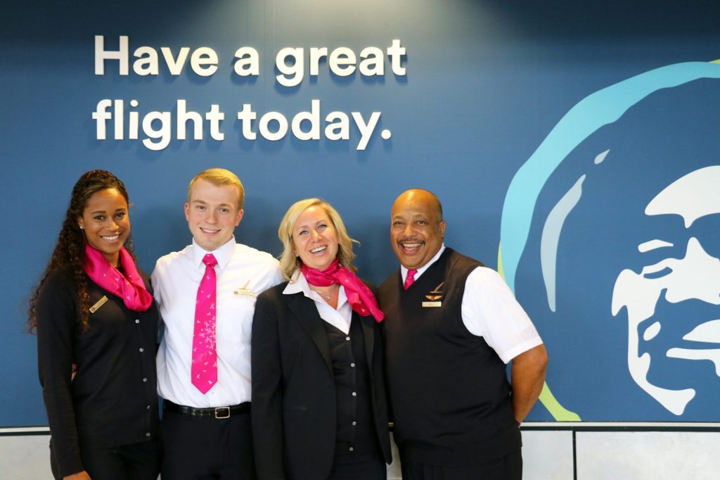 Alaska Airlines employees model breast cancer awareness scarves and ties