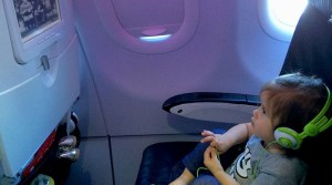 This is a photo of a child watching a movie on an airplane.